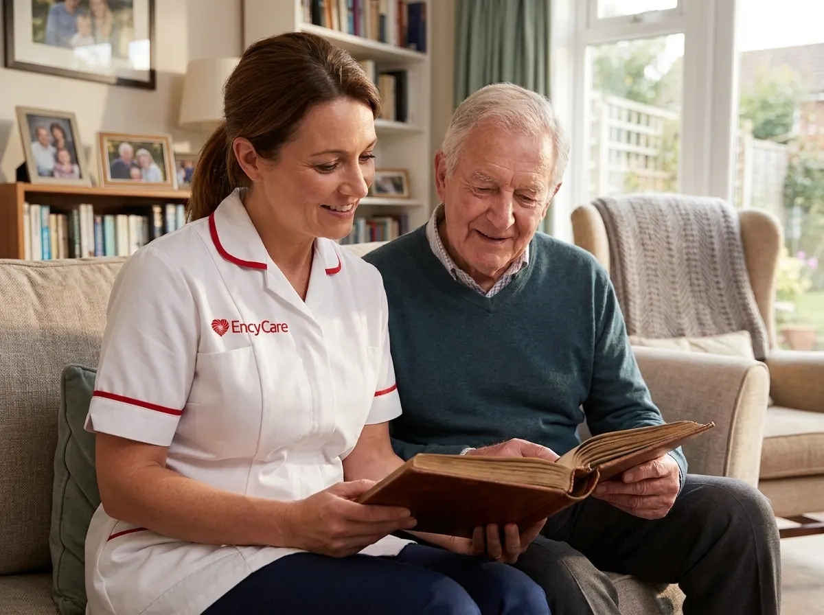 European carer in white Ency Care uniform looking through a photo album with a client living with dementia
